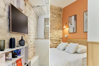 Un ou plusieurs lits dans un hébergement de l'établissement Residence Le Marais by Studio prestige