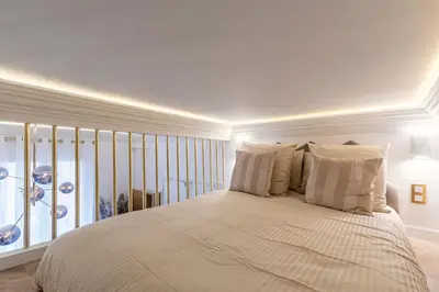 Un ou plusieurs lits dans un hébergement de l'établissement Studio avec mezzanine Arc de Triomphe