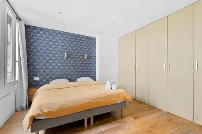 Un ou plusieurs lits dans un hébergement de l'établissement Lovely Apartment, heart of Paris center
