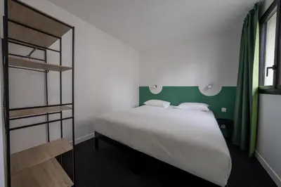 Un ou plusieurs lits dans un hébergement de l'établissement Beau M Paris