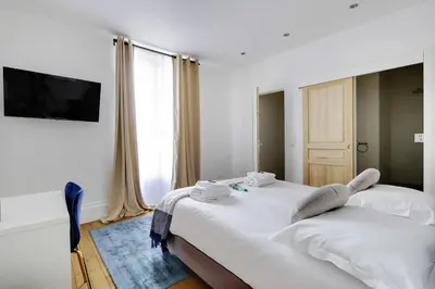 Un ou plusieurs lits dans un hébergement de l'établissement Classy appartment - Arc de Triomphe