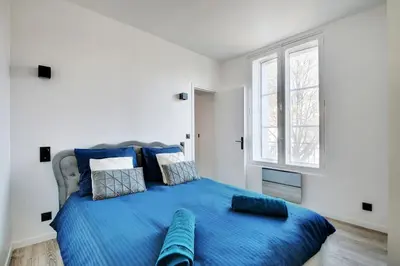 Un ou plusieurs lits dans un hébergement de l'établissement Appartement aux Portes de Paris