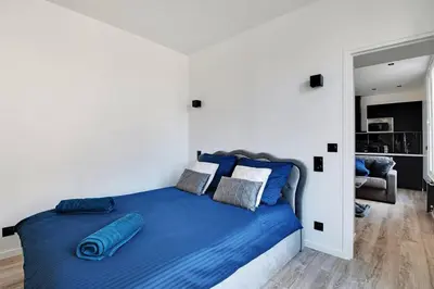 Un ou plusieurs lits dans un hébergement de l'établissement Appartement aux Portes de Paris