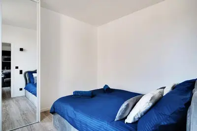Un ou plusieurs lits dans un hébergement de l'établissement Appartement aux Portes de Paris