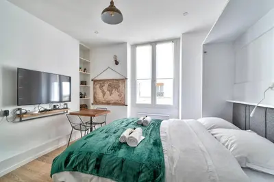 Un ou plusieurs lits dans un hébergement de l'établissement Magnifique studio au coeur de Paris