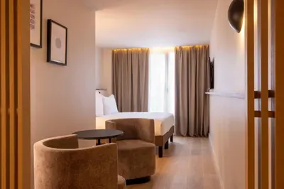 Un ou plusieurs lits dans un hébergement de l'établissement Hôtel Esté