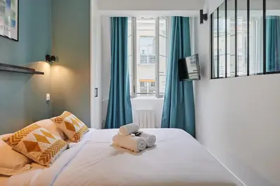 Un ou plusieurs lits dans un hébergement de l'établissement Residence Center of Paris by Studio prestige