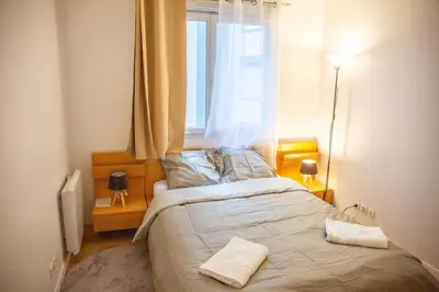 Un ou plusieurs lits dans un hébergement de l'établissement Grand 2 pièces balcon Parking porte PARIS