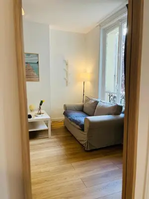 Coin salon dans l'établissement Cozy historic appartement near Exelmans in 16th District Paris