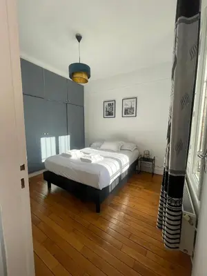 Un ou plusieurs lits dans un hébergement de l'établissement appartement a 15 minute de centre de paris