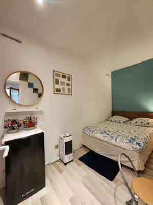Un ou plusieurs lits dans un hébergement de l'établissement Home Cosy ARENA Porte de la Chapelle