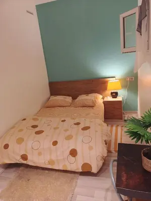 Un ou plusieurs lits dans un hébergement de l'établissement Home Cosy ARENA Porte de la Chapelle