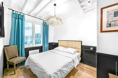 Un ou plusieurs lits dans un hébergement de l'établissement Palais Royal - Victoires 1bdr by B'Your Home