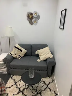 Coin salon dans l'établissement Charmant appartement - PARIS 18