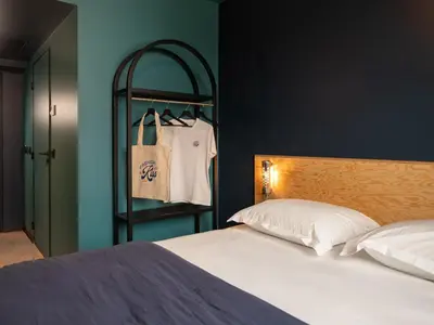 Un ou plusieurs lits dans un hébergement de l'établissement Eklo Hotels Paris Porte de Versailles