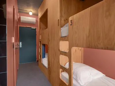 Un ou plusieurs lits dans un hébergement de l'établissement Eklo Hotels Paris Porte de Versailles