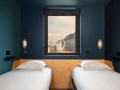 Un ou plusieurs lits dans un hébergement de l'établissement Eklo Hotels Paris Porte de Versailles