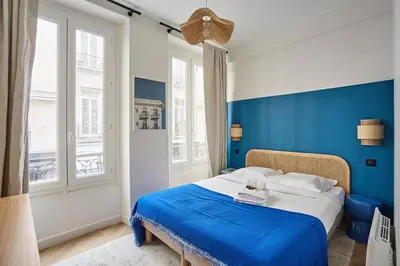 Un ou plusieurs lits dans un hébergement de l'établissement Duplex Center of Paris by Studio prestige